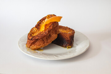 Plate  with three Torrijas Spanish french toast  isolated on white background