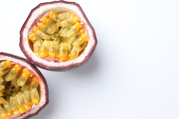 Halves of fresh passion fruit on white background, closeup. Space for text