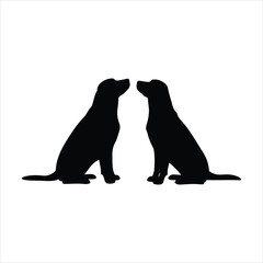 Two black labrador retrievers silhouetted facing each other sharing an affectionate moment