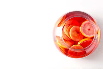 Tasty fruity punch on white table, top view with space for text. Refreshing drink