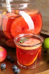 Tasty punch and fruits on wooden table, closeup. Refreshing drink