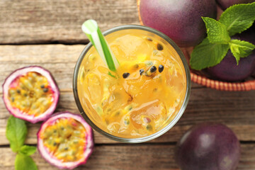Tasty passion fruit drink with mint and fresh fruits on wooden table, flat lay