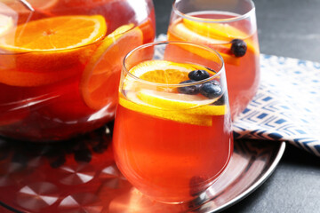 Fruity punch on black table, closeup. Refreshing drink