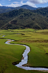 Obraz premium Vast and breathtaking, the Huaylla Belén Valley in Amazonas, Peru unfolds in gentle curves of grassland and water—where the Andes and sky meet in quiet harmony.