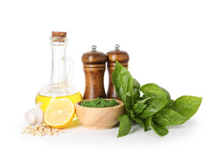 Fresh pesto sauce in bowl and ingredients isolated on white