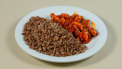 Buckwheat with chicken sauce on plate