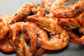 Tasty grilled shrimps on grey table, closeup. Delicious seafood dish