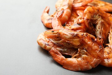Delicious seafood dish. Tasty grilled shrimps on grey table, closeup. Space for text
