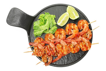 Skewers with tasty grilled shrimps, lime slices and lettuce isolated on white, top view. Delicious seafood dish