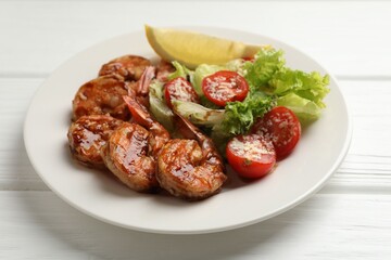 Tasty grilled shrimps with salad on white wooden table, closeup. Delicious seafood dish