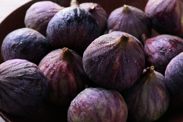 Many fresh ripe figs in bowl, closeup
