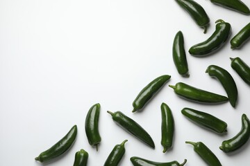 Green jalapeno peppers on white background, flat lay. Space for text