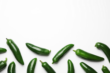 Green jalapeno peppers on white background, flat lay. Space for text