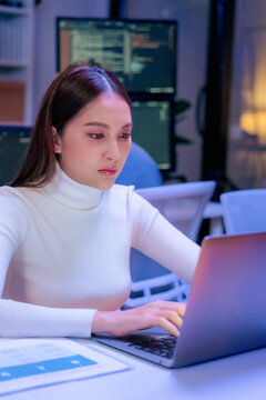 Asian programmer leverages generative AI assistance for deep learning and data driven analysis, optimizing a scalable, cloud native workflow in their modern, hyper automated smart office