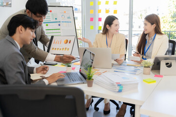 Marketing concept with laptop in office, Asian business group teamwork brainstorming meeting and discussing strategy, financial analysis, successful plan.