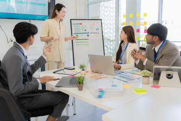 Marketing concept with laptop in office, Asian business group teamwork brainstorming meeting and discussing strategy, financial analysis, successful plan.