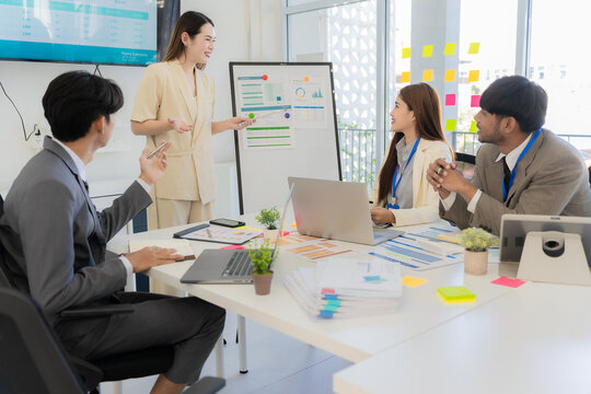 Marketing concept with laptop in office, Asian business group teamwork brainstorming meeting and discussing strategy, financial analysis, successful plan.