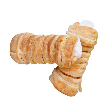 Flatlay of two Cannoncini flaky puff pastry cream horns isolated over white