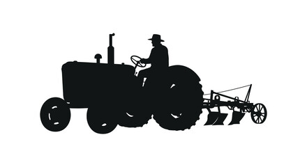 A silhouette of a farmer driving an antique tractor in a field © Jewel