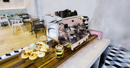 In a modern cafe, a sleek coffee machine shines on a wooden countertop, surrounded by enticing pastries and vibrant drinks, inviting patrons to savor their favorite brews.
