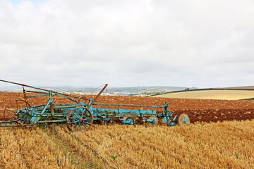 Fototapeta premium Vintage tractor ploughing a field 
