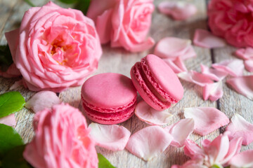 A cup of aromatic tea, a book and a rose on the table.