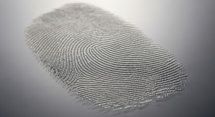 Close-up of a clear, detailed fingerprint impression on a light gray surface.