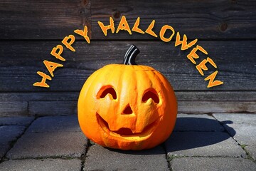 Carved pumpkin in front of a wooden background with the text "Happy Halloween." Halloween concept.