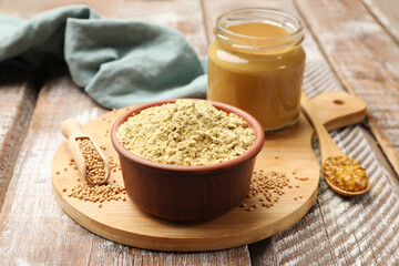 Different types of mustard on wooden table, closeup