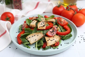 Tasty salad with eryngium mushrooms, vegetables, spinach and sesame on white table, closeup