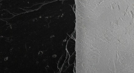 Abstract contrast of black and textured gray surfaces meeting at a sharp dividing line
