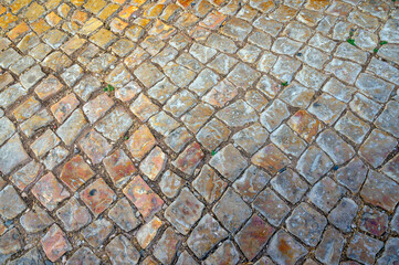 Ancient European weathered cobblestone pavement colorful golden hour historic street walkway stone path travel background copy space