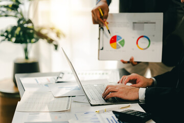 Young colleagues discussing business and price chart analyzes business people on the table great in...