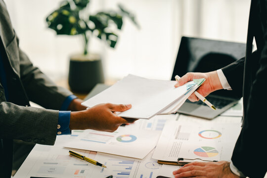 Young colleagues discuss business brainstorming and price charts analyze business people at the desk brilliantly in modern collaborative office teamwork ideas. Calculate personal tax for customers