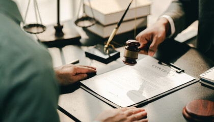 concept of justice and law A male judge in the courtroom on a wooden table and a male counselor or...