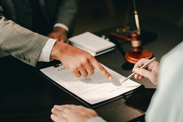 concept of justice and law A male judge in the courtroom on a wooden table and a male counselor or...