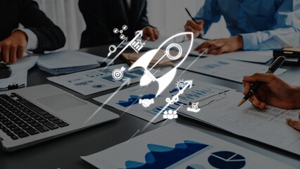A dynamic business meeting showing a team collaborating on growth strategies with documents and a laptop, symbolized by an innovative rocket icon for inspiration. Raster