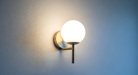 Modern oval sconce light fixture illuminating a textured wall