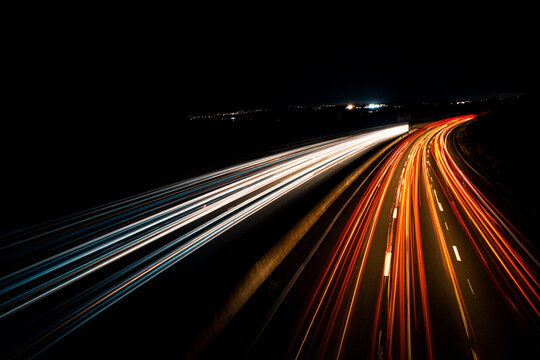 Lights of cars in motion, creating light trails, lines from car headlights