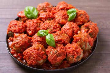 Juicy pan seared beef meatballs with tomato sauce