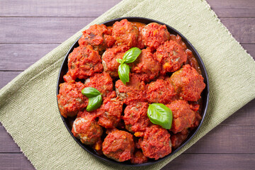 Juicy pan seared beef meatballs with tomato sauce. View from above, top studio shot