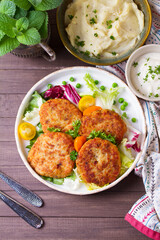 Fish patty burgers served with vegetables. Fish cakes. High angle view