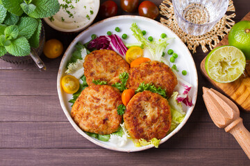 Fish patty burgers served with vegetables. Fish cakes. High angle view