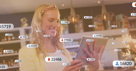 Monitoring staff using tablet smartphone with floating icons at cafe counter with jars on shelves