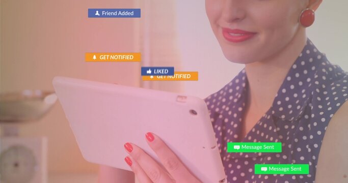 Woman in polka-dot top holding tablet, tapping screen at home, with media alerts, copy space