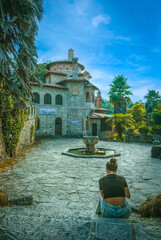 Girl seated in front of Historic Vila Sassetti in Sintra, Portugal