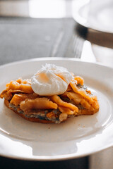 Morning breakfast, toast with bread and salmon, and poached egg.