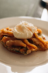 Morning breakfast, toast with bread and salmon, and poached egg.