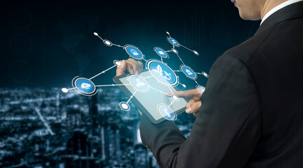 A business professional interacts with a futuristic digital interface on a tablet, emphasizing technology, connectivity, and data analysis in an urban environment. Tessel