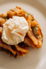 Morning breakfast, toast with bread and salmon, and poached egg.